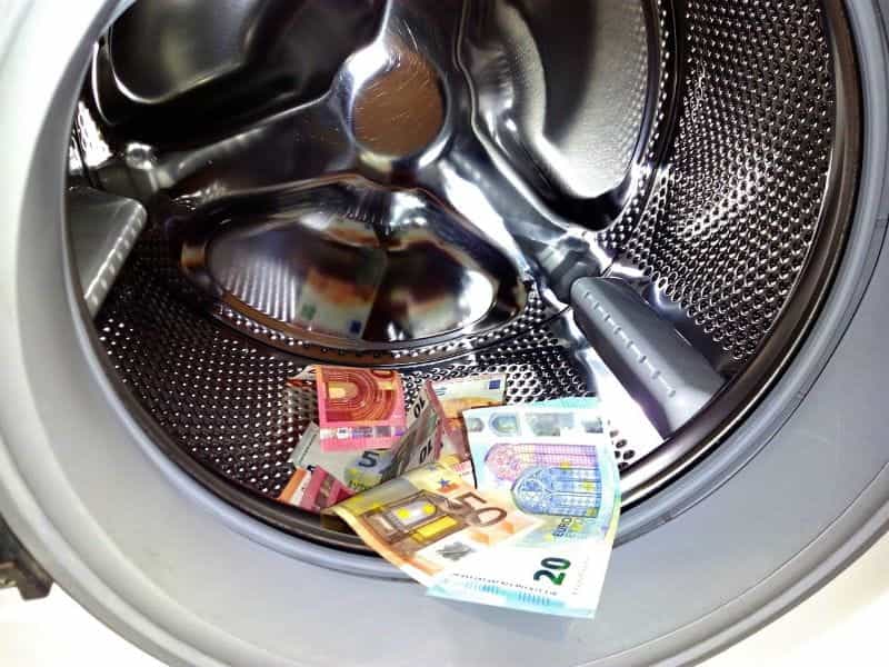 A washing machine drum filled with Euro banknotes.