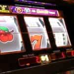 Three cherries appear on the first reel of a slot machine interface.