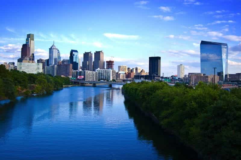 Downtown Pennsylvania, Philadelphia during the day, with a broad river featured prominently in the center.