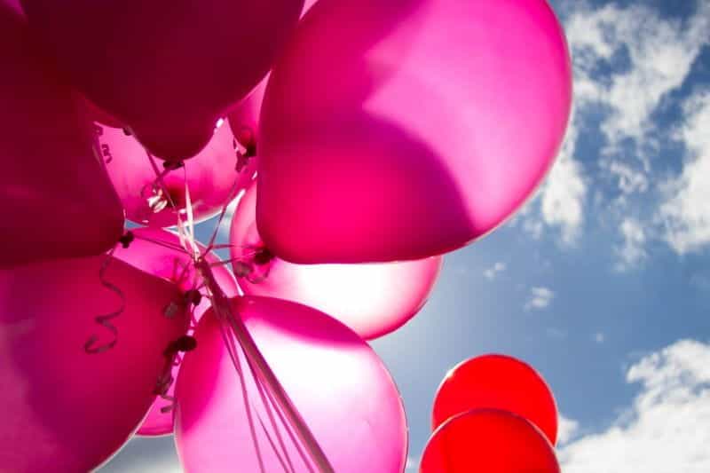 Pink balloons against a blue sky.