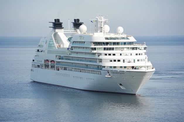 A large white cruise ship sailing in the middle of the ocean.