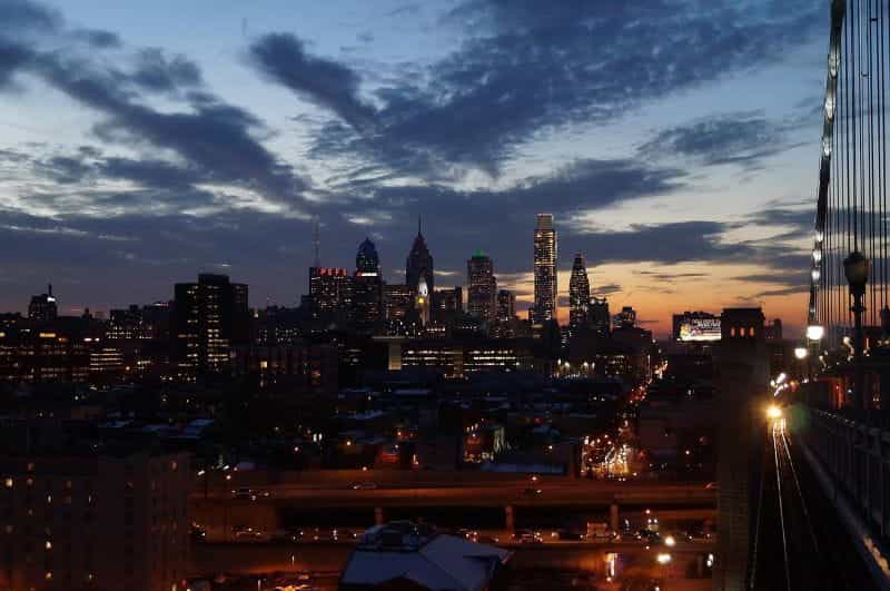 Downtown Philadelphia at night, with a prominent view of its skyscrapers and overall skyline.