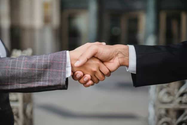 Two business people shake hands on a deal.