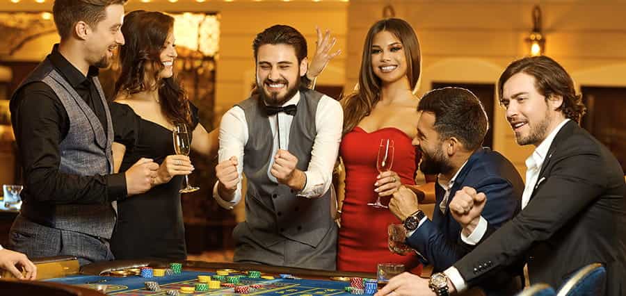 A group of gamblers playing at a roulette table.
