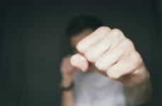 A fist punches towards the camera.