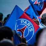 A blue and red flag bearing the symbol of French football club Paris Saint-Germain.