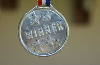 A silver medal with the word “Winner” emblazoned on it.