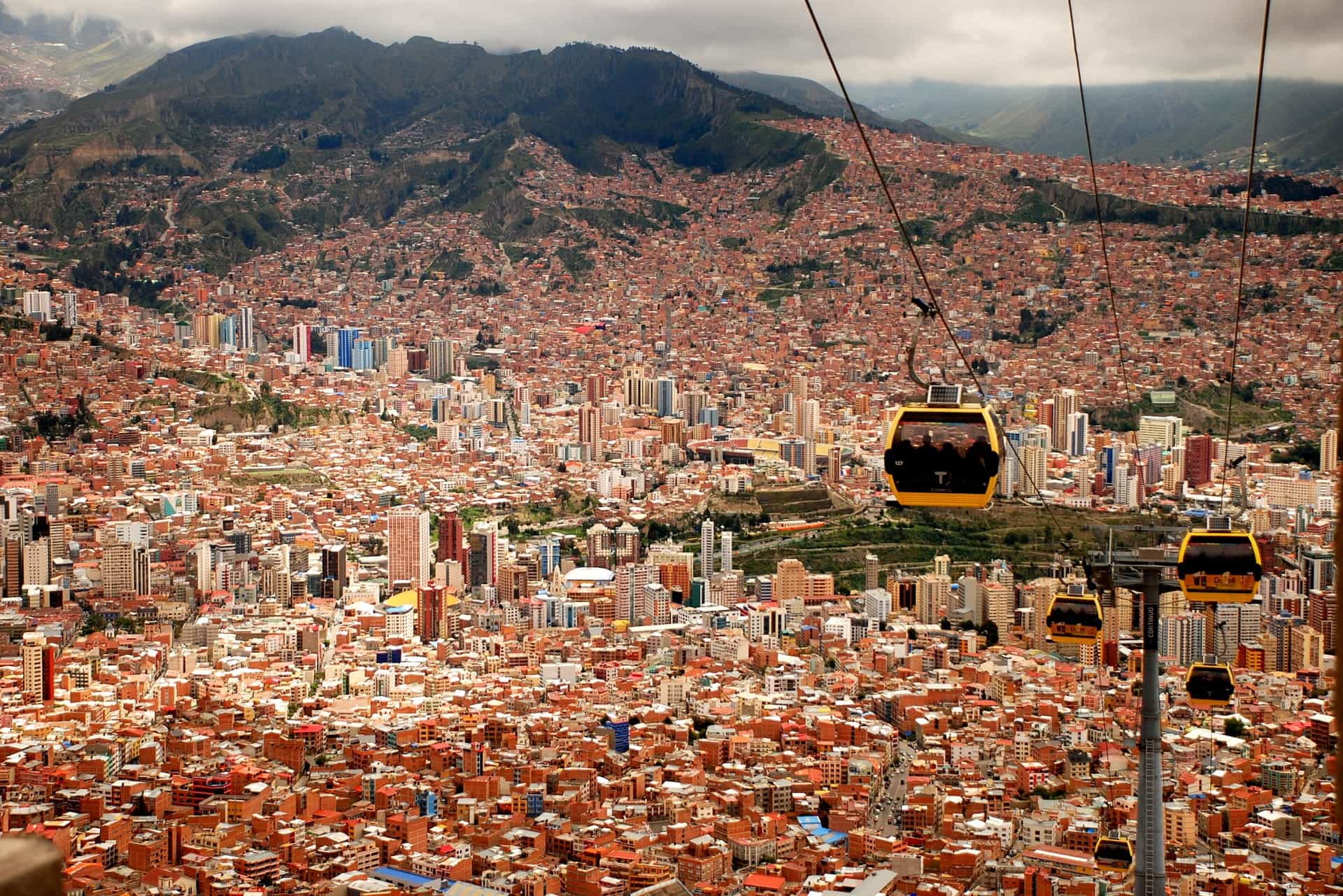 Cable cars overlook a sprawling Bolivian city.
