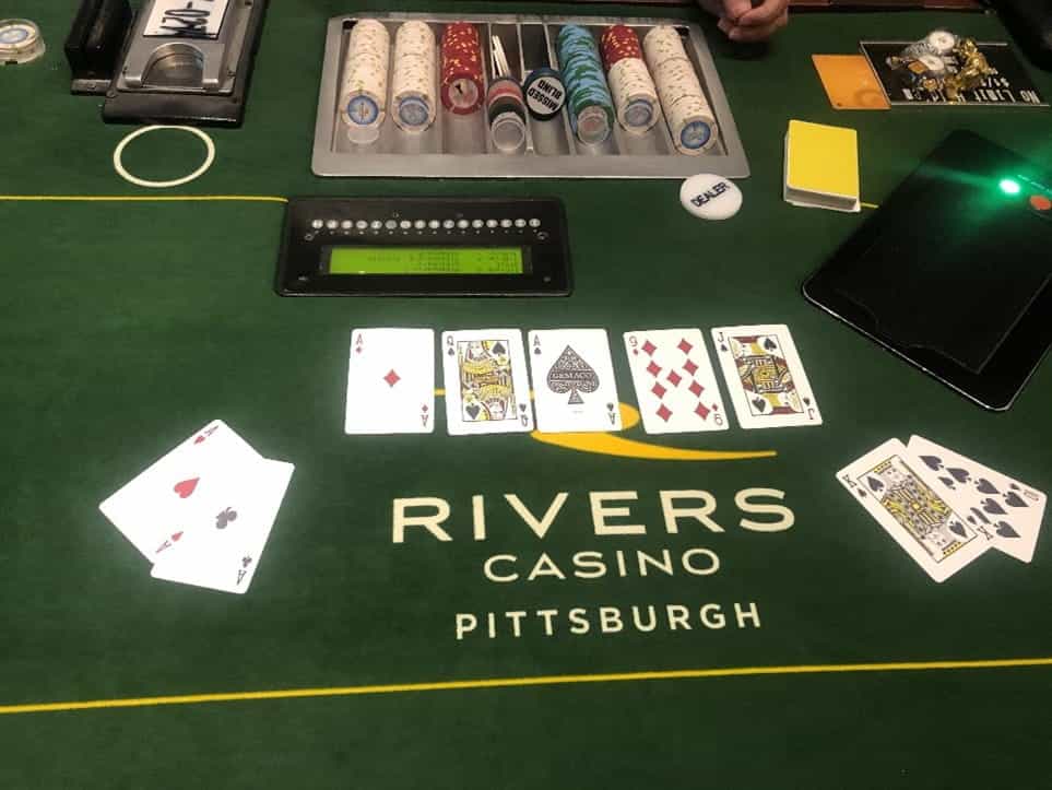 Four Aces and a Royal Flush displayed on a Rivers Casino poker table. 