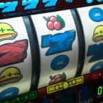 Slot machine displaying three sevens.