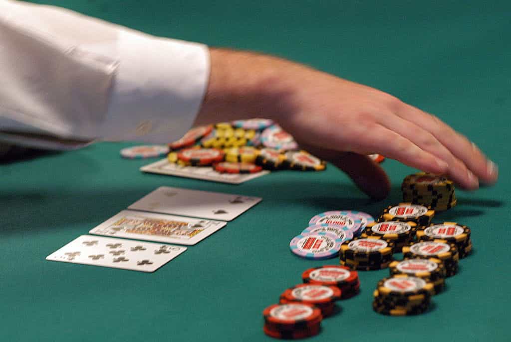 A dealer counts out chips during a hand of Texas Hold’em.
