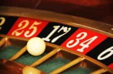 A classic game of roulette at a casino, with the ball spinning around the roulette wheel.