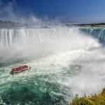 Niagara Falls with a tourist observation deck boat.