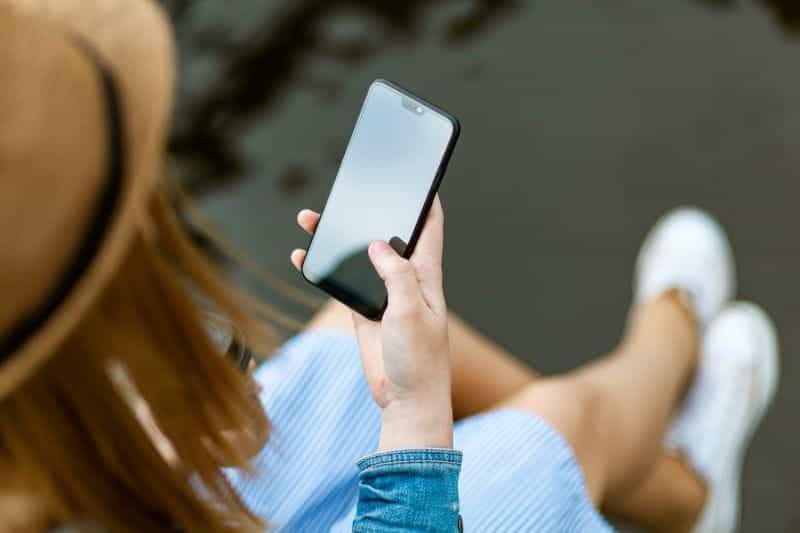 A woman looking at a mobile phone.