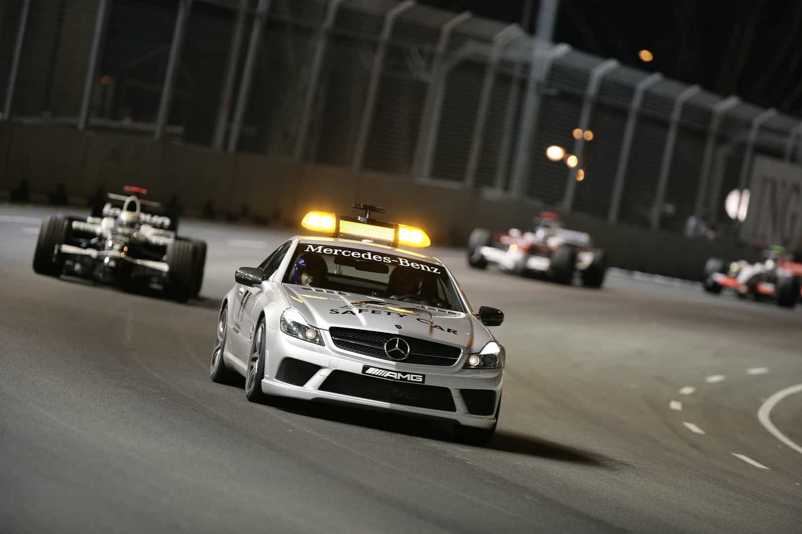 The field follow the safety car at the 2008 Singapore Grand Prix.