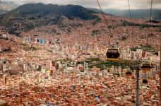 A crowded Bolivian city featuring cable cars.