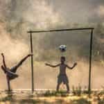 Children playing football in Asia.