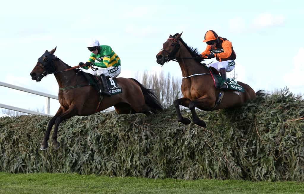 Sam Waley-Cohen and Noble Yeats jump the last flight in the 2021 Grand National alongside Mark Walsh and his mount, Any Second Now.