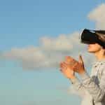 A woman wearing a Virtual Reality headset.