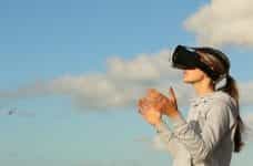 A woman wearing a Virtual Reality headset.