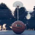 A stationary NBA branded basketball on a basketball court.