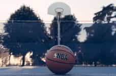 A stationary NBA branded basketball on a basketball court.