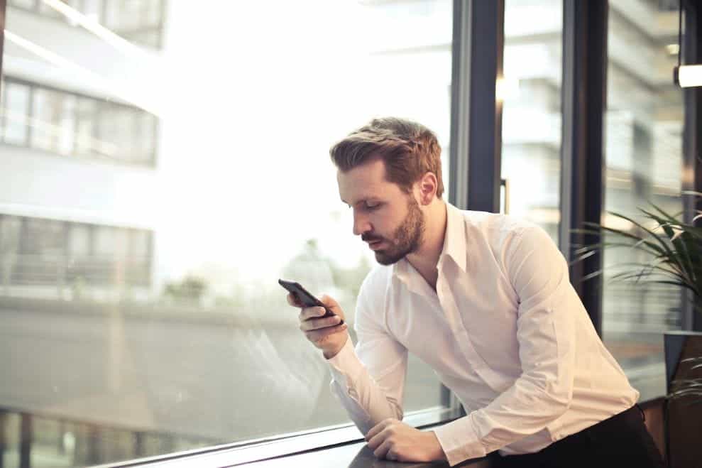 A man looking at a mobile phone.
