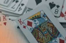 A king of diamonds placed on top of a deck of out of focus cards.