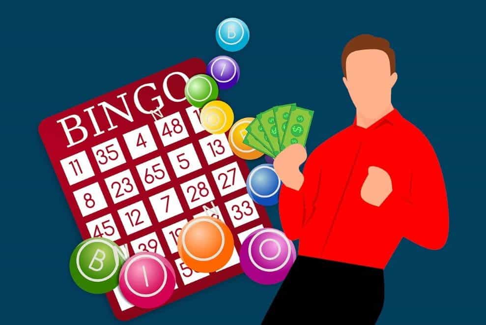 Seorang pria berbaju merah memegang seikat dolar hijau AS di tangan kanannya di samping kartu bingo dan sekelompok bola lotere.