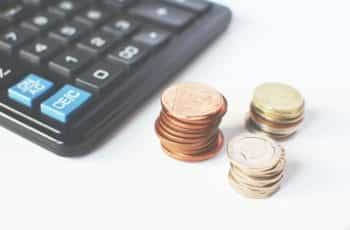 Coins next to a calculator.
