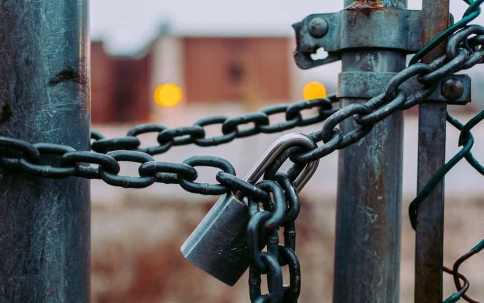 A lock holding together a chained up gate.
