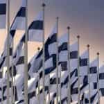 A number of Finland flags lined up in rows.