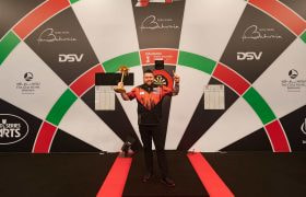 Winner Michael Smith poses with his Bahrain Darts Masters trophy.