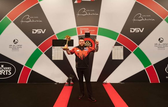 Winner Michael Smith poses with his Bahrain Darts Masters trophy.