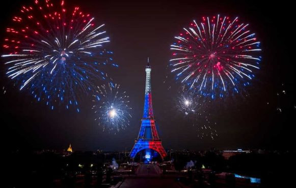 Fireworks explode above the Eiffel Tower in Paris.