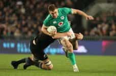 Garry Ringrose of Ireland is tackled by Brodie Retallick of the All Blacks during in an International test match at Eden Park