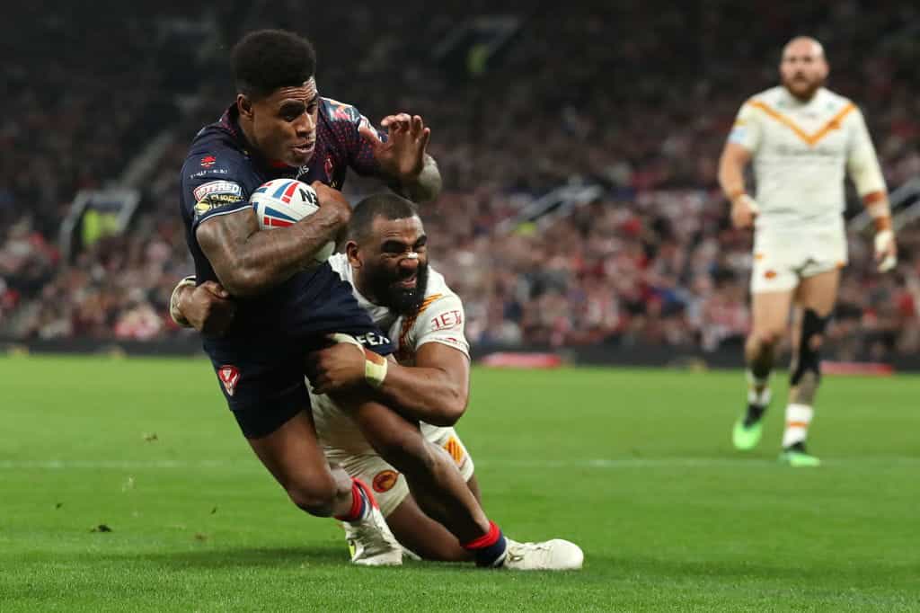 Julian Bousquet of Catalans Dragons attempts to tackle Kevin Naiqama of St Helens.