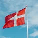 Red flag with a white cross fluttering in the breeze
