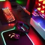 Gaming set with neon lights on a desk.