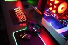 Gaming set with neon lights on a desk.