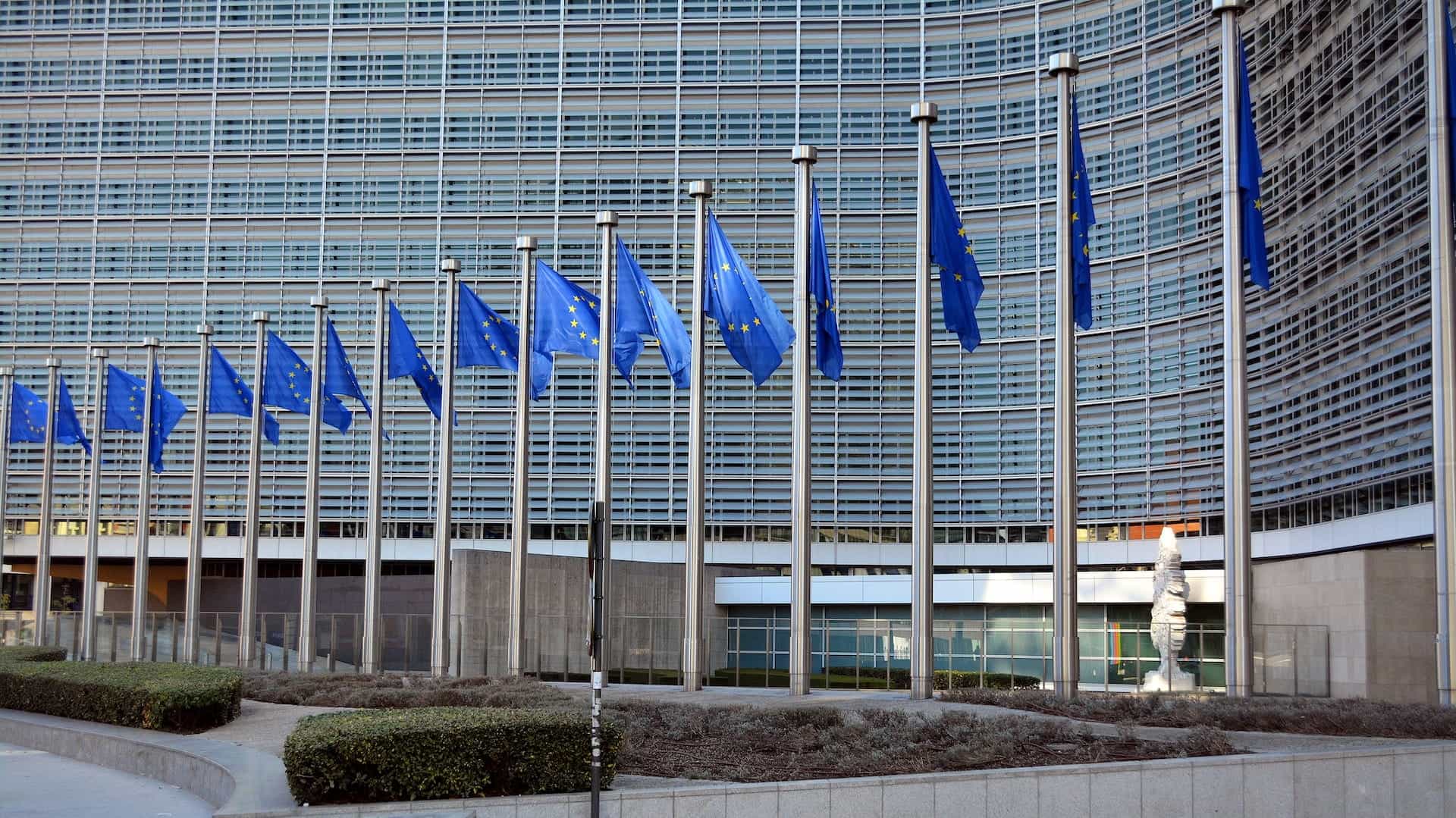 A row of EU flags wave on poles in Brussels, Belgium.