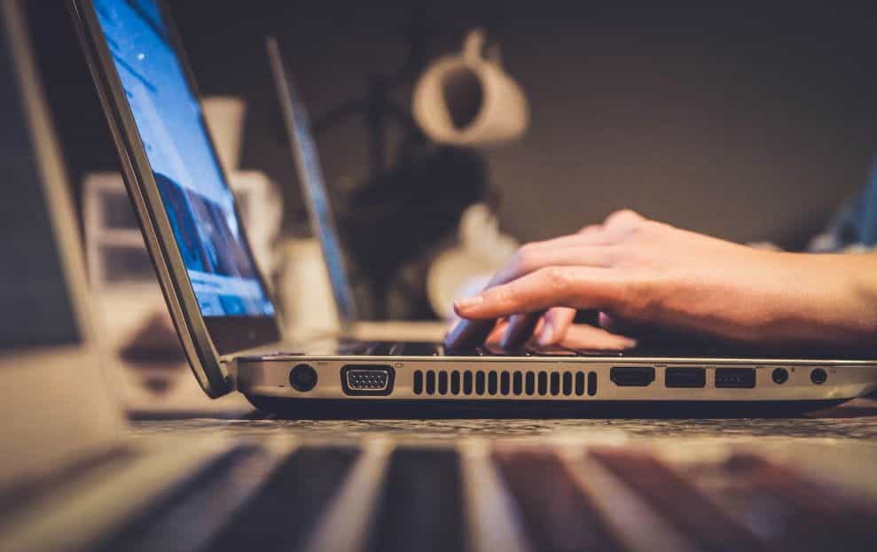 Person using a silver laptop.