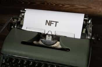 A typewriter with NFT written on paper.