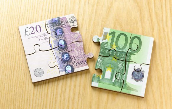 Euro and British Notes created to appear like jigsaw pieces.