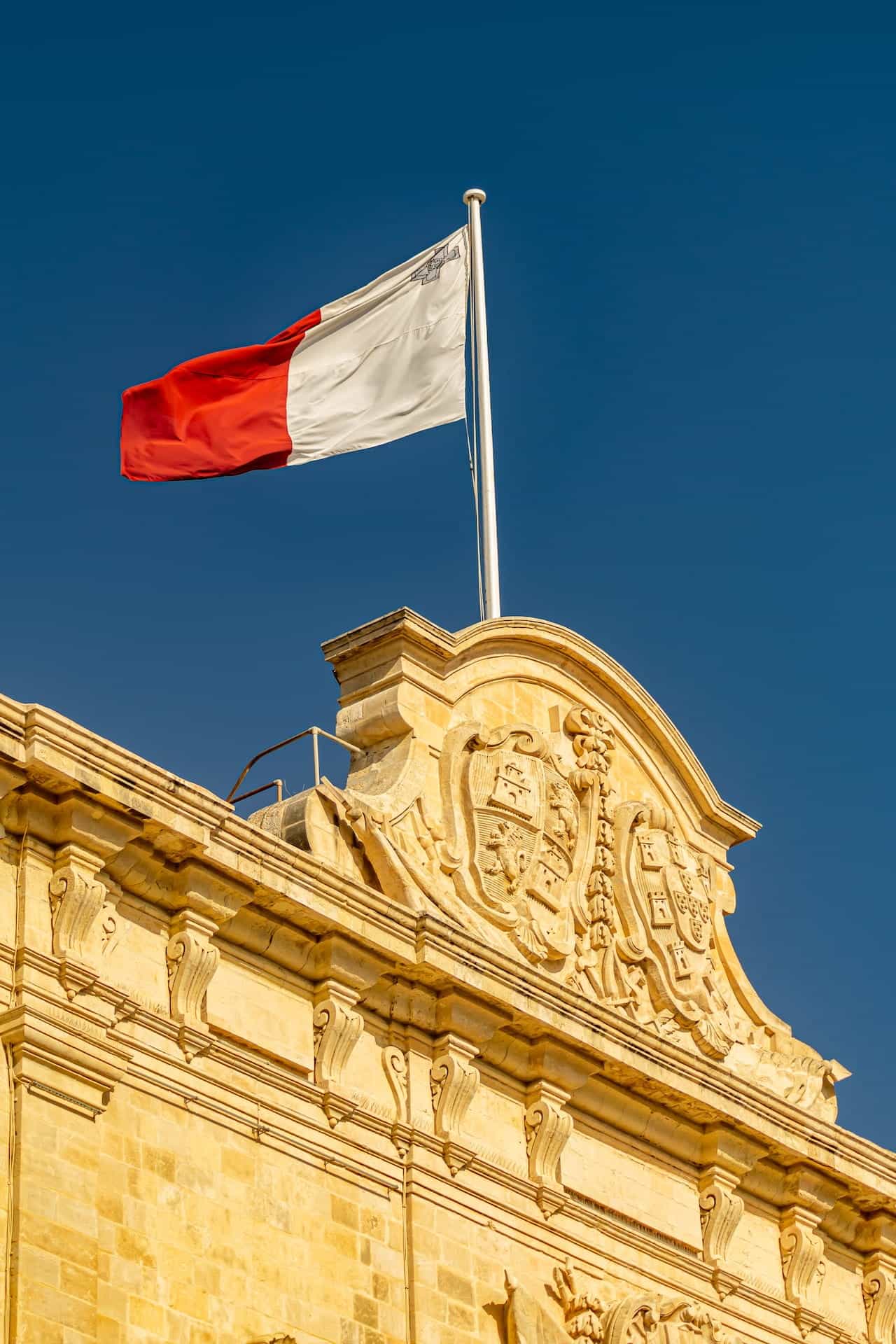 Flag of malta fluttering in the breeze on a sunny day.