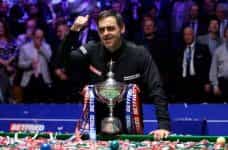 Ronnie O’Sullivan shows off his 2022 World Championship trophy.