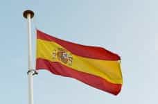 The Spanish flag waves in a flagpole.