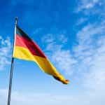 German flag against blue sky.