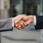 Two business people shaking hands on a deal.
