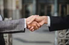 Two business people shaking hands on a deal.